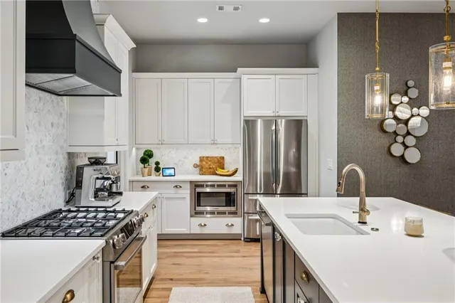 a bedroom with a bed a window and a chandelier