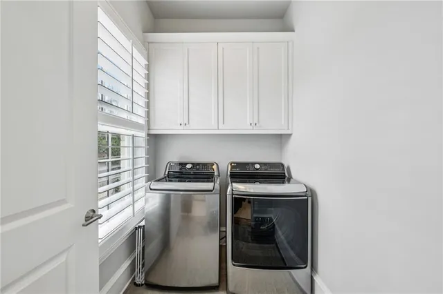 a view of walk in closet with clothes