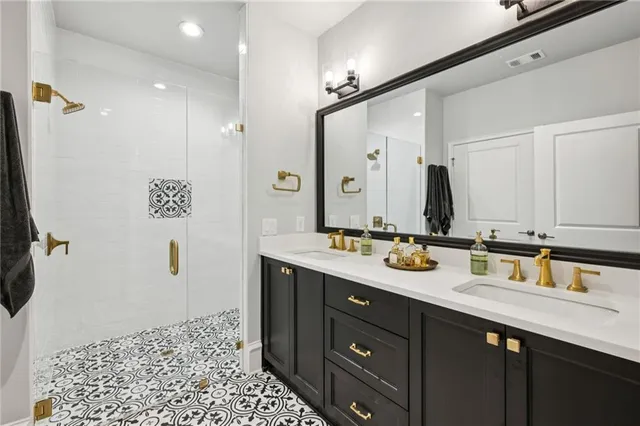 a bathroom with a granite countertop sink toilet and shower