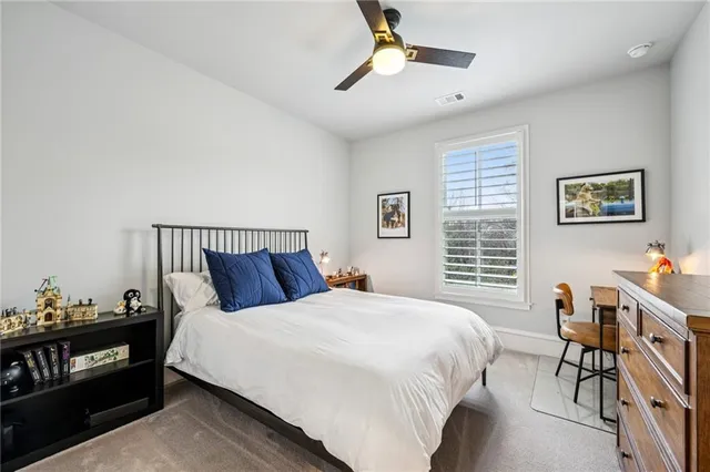 a view of a hallway to a livingroom with furniture