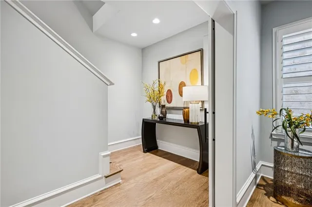 a view of a hallway with wooden floor