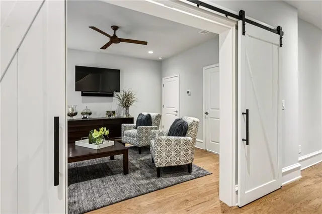 an aerial view of residential houses with outdoor space and trees