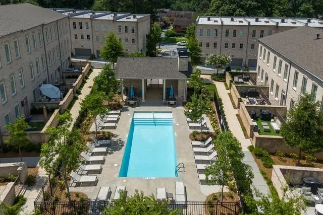 an aerial view of a residential houses with outdoor space
