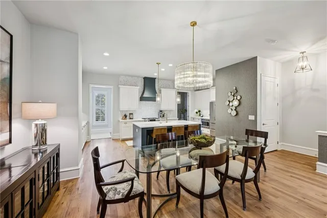 a kitchen with a table chairs stove and cabinets