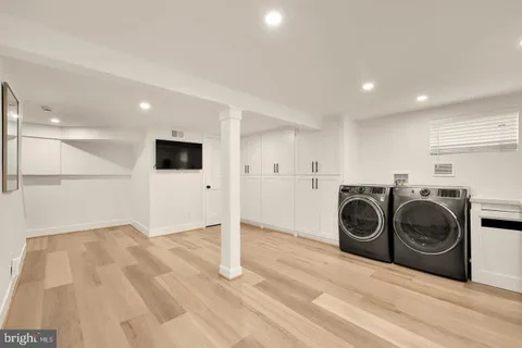 a utility room with sink dryer and washer