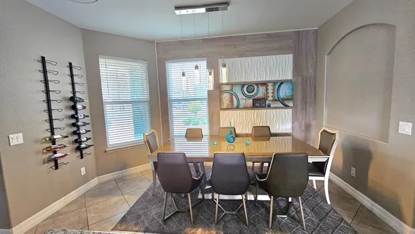 a kitchen with stainless steel appliances granite countertop a refrigerator a stove and a sink with wooden floor