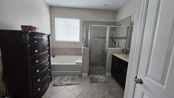a bathroom with a granite countertop sink a toilet and bathtub