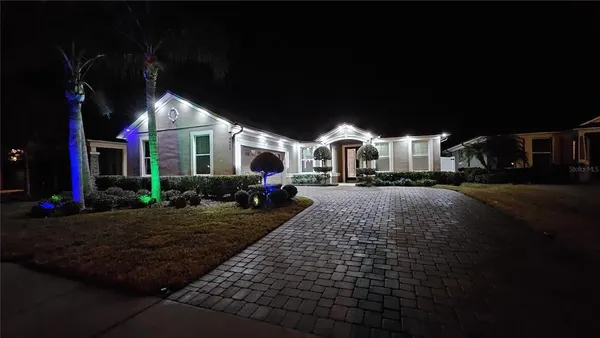 a view of a white house with large windows and table