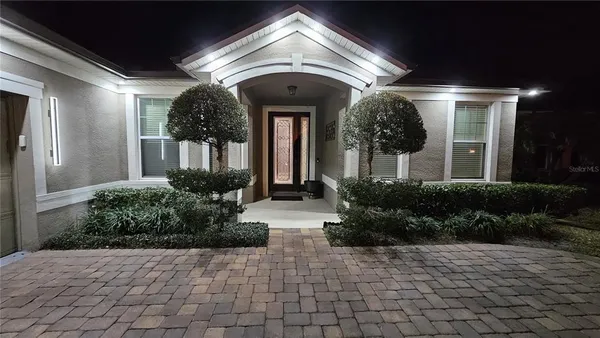 a view of a lobby with pathway and flower plants