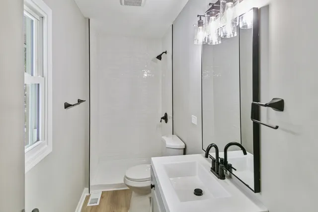 a bathroom with a sink toilet and shower