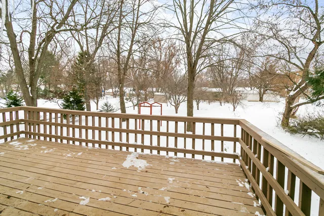 a view of deck with wooden floor and trees