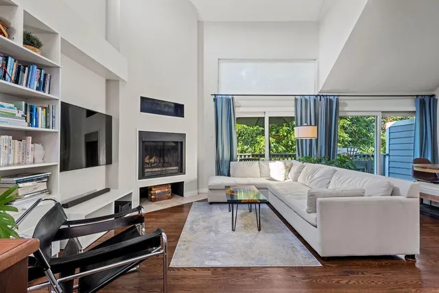 a living room with furniture fireplace and a flat screen tv
