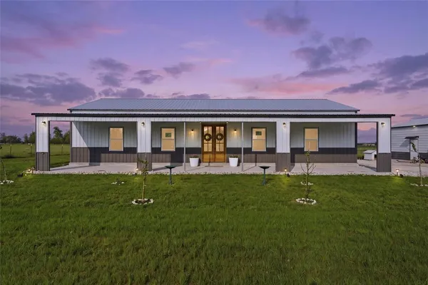 a house view with swimming pool and garden space