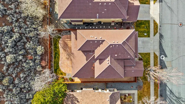 an aerial view of a house with a yard