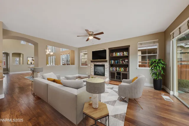 a living room with furniture a fireplace and a table