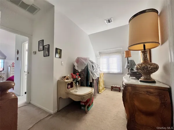 a living room with furniture and a mirror