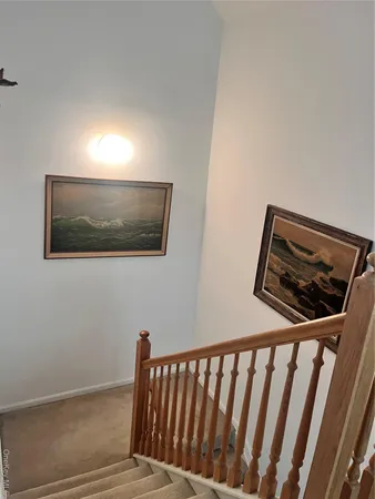 a view of a hallway with wooden floor and a floor to ceiling window