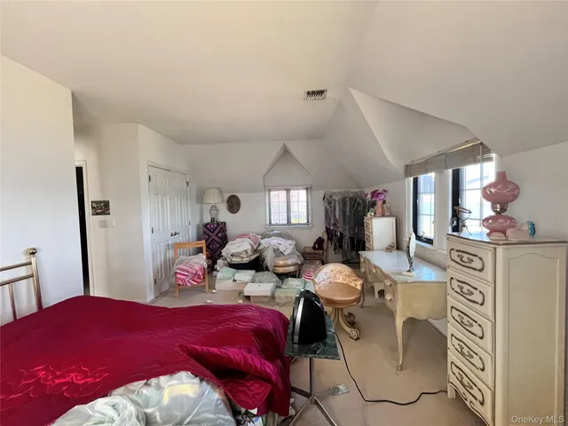 a bedroom with bed and a chandelier