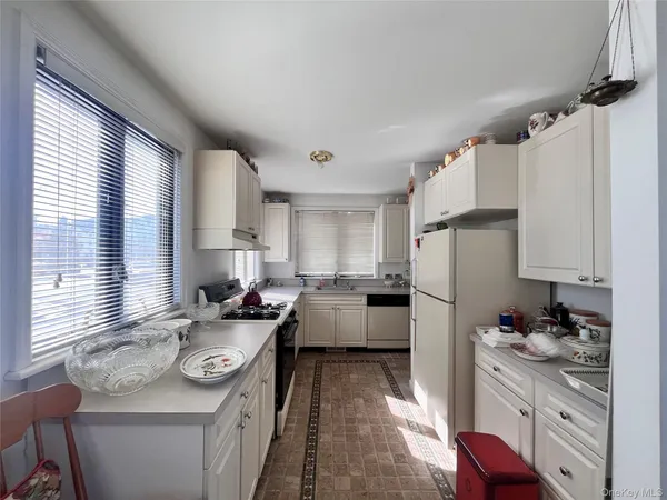 a kitchen with a sink stove and refrigerator
