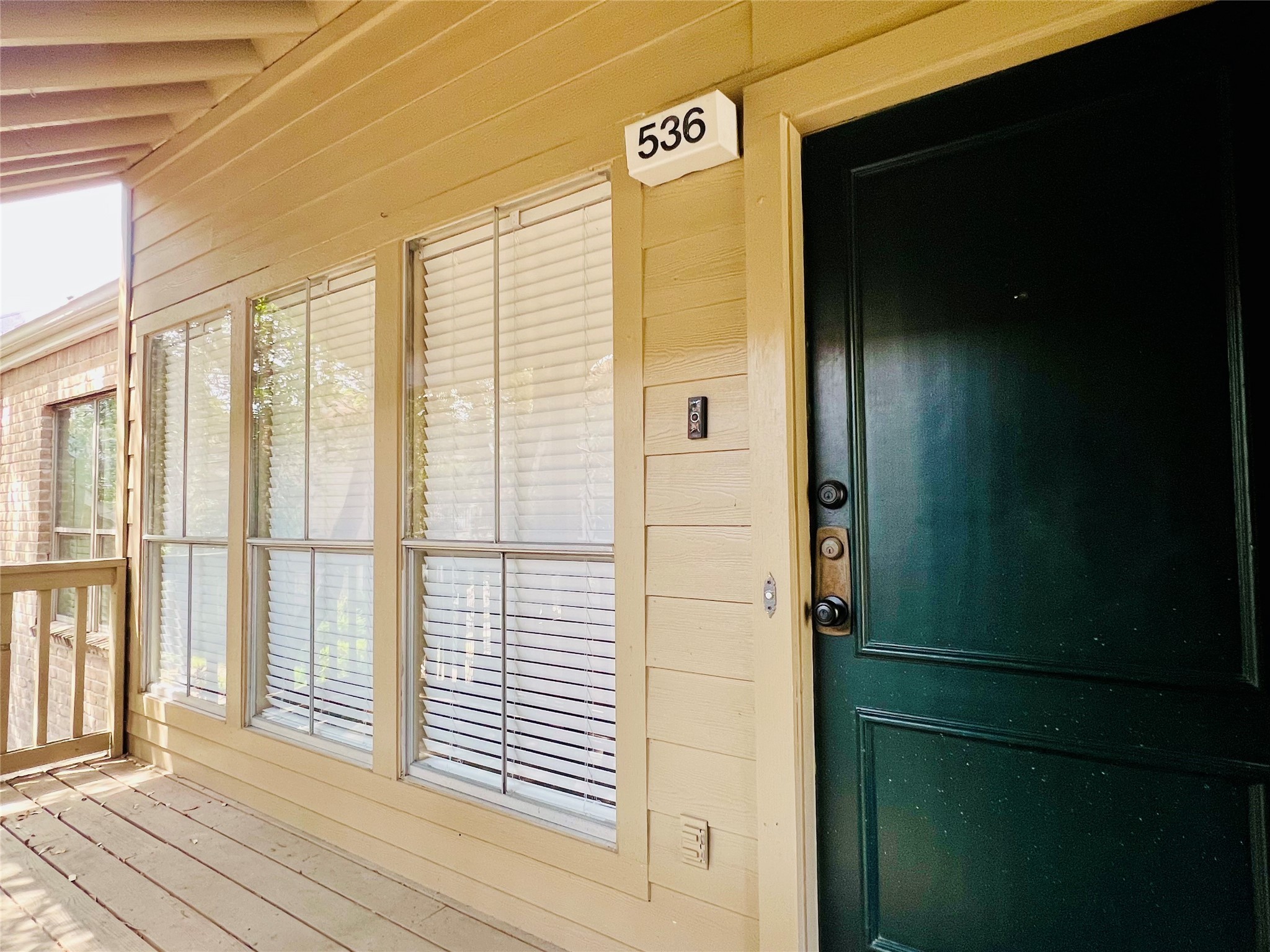 2100 Tanglewilde Street, Unit 536 Houston, TX 77063 - Photo 2 of 37 a view of a porch with wooden floor and a window