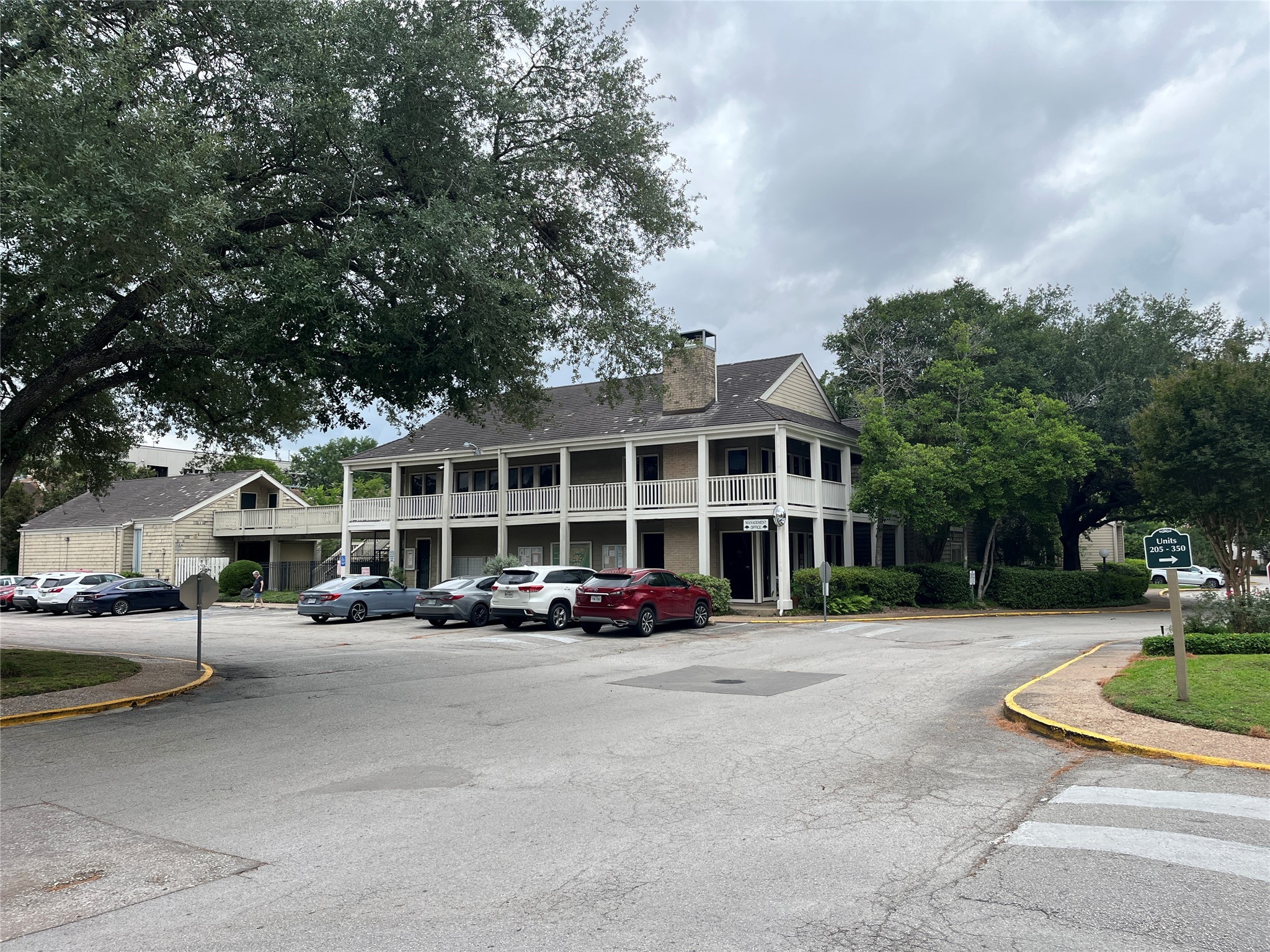 2100 Tanglewilde Street, Unit 536 Houston, TX 77063 - Photo 30 of 37 a front view of a building with street and trees