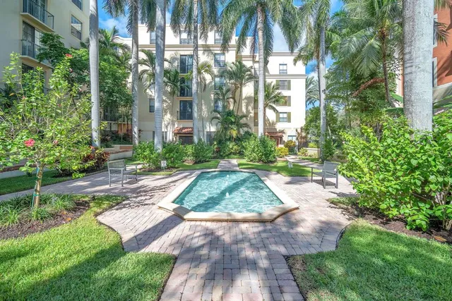 a view of backyard with plants and outdoor seating