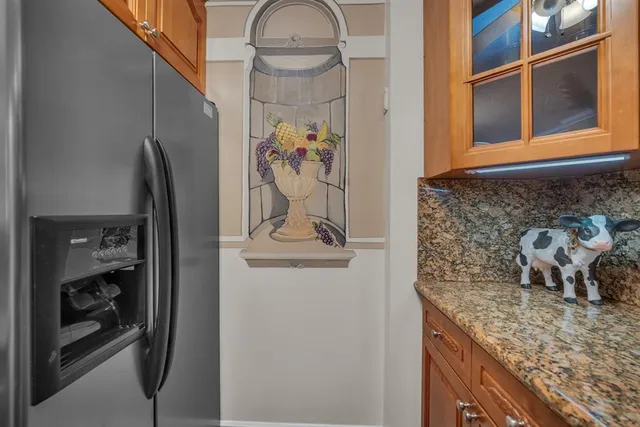 a bathroom with a granite countertop sink a mirror and shower