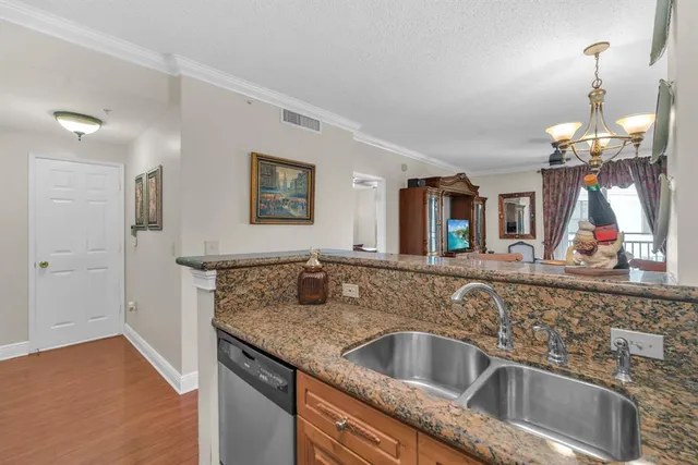 a kitchen with a sink and a wooden floor