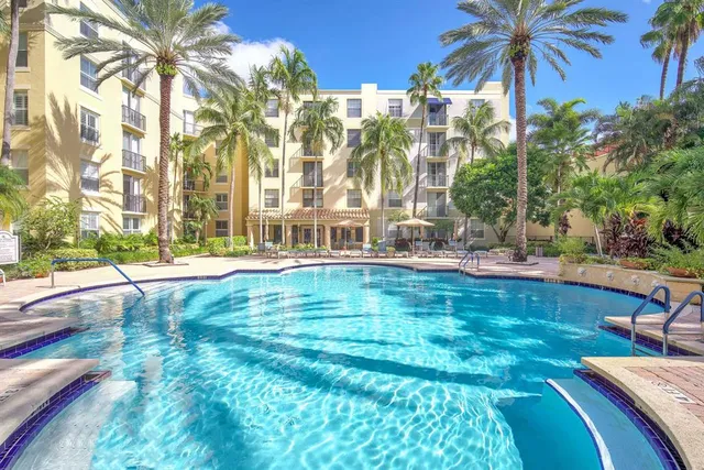 a swimming pool with outdoor seating and yard
