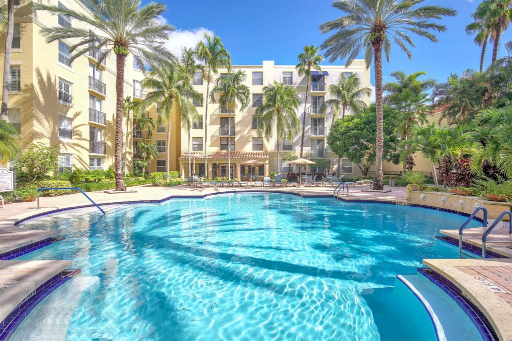 630 South Sapodilla Avenue, Unit 407 West Palm Beach, FL 33401 - Photo 17 of 25 a swimming pool with outdoor seating and yard