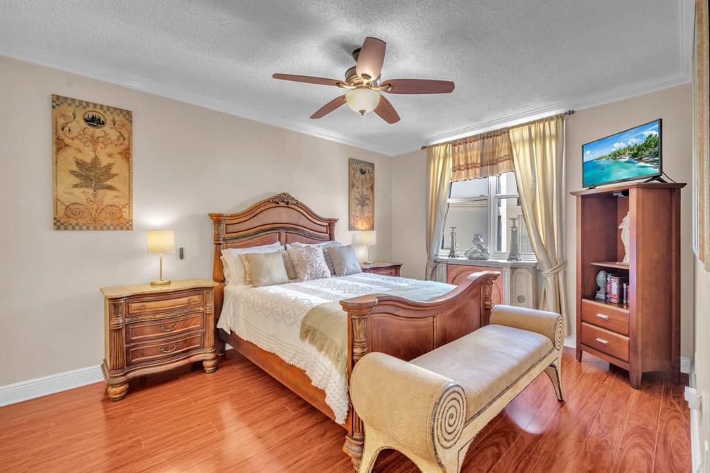 630 South Sapodilla Avenue, Unit 407 West Palm Beach, FL 33401 - Photo 2 of 25 a bedroom with furniture and a window