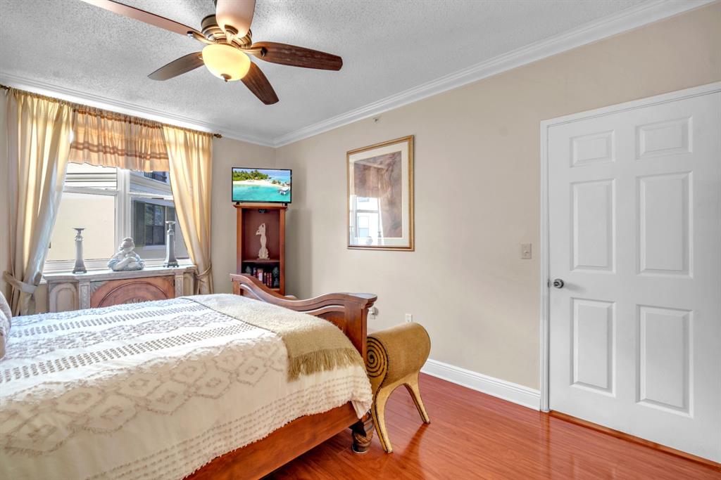 630 South Sapodilla Avenue, Unit 407 West Palm Beach, FL 33401 - Photo 3 of 25 a bedroom with a bed dresser and a window