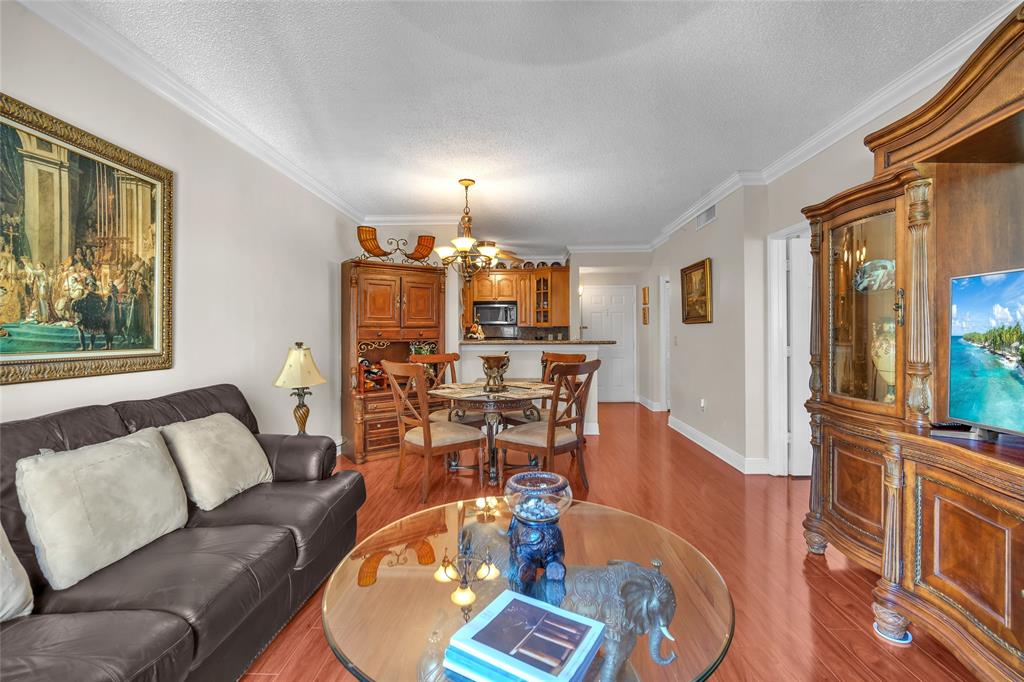 630 South Sapodilla Avenue, Unit 407 West Palm Beach, FL 33401 - Photo 6 of 25 a living room with furniture a flat screen tv and wooden floor