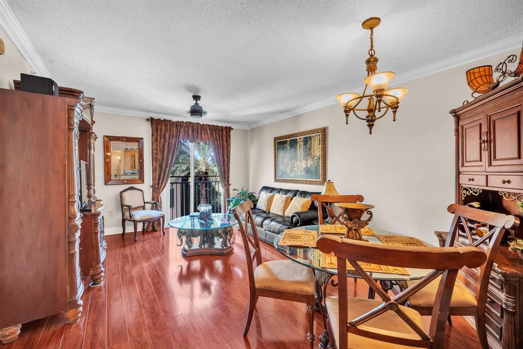 630 South Sapodilla Avenue, Unit 407 West Palm Beach, FL 33401 - Photo 9 of 25 a view of a dining room with furniture window and wooden floor