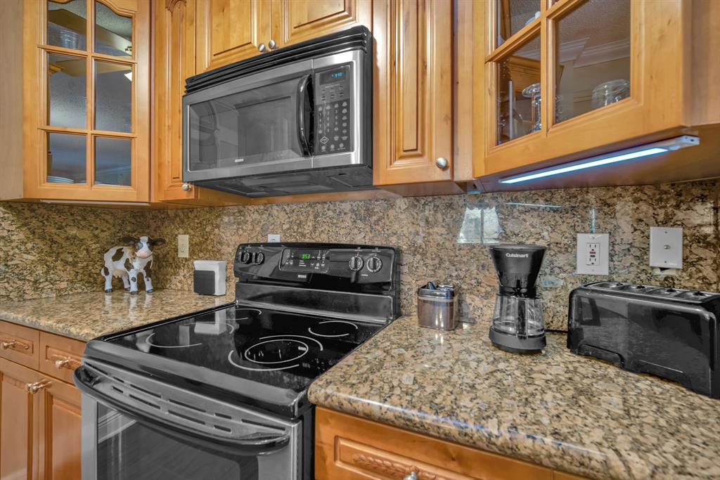 630 South Sapodilla Avenue, Unit 407 West Palm Beach, FL 33401 - Photo 10 of 25 a kitchen with a stove and a sink