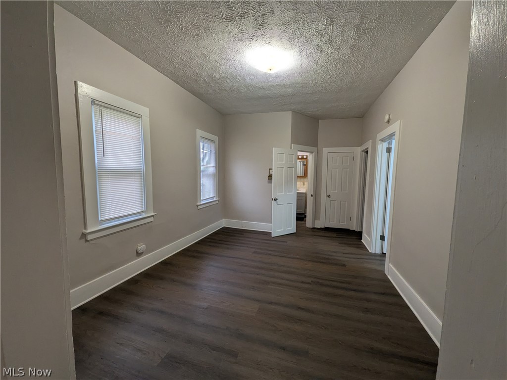 1881 Manchester Road, Unit 1 Akron, OH 44314 - Photo 7 of 44 1881 Manchester Rd, Akron, OH 44314 Unit #1 ground floor access and living. Welcome to this spacious 2-bedroom, 1-bathroom first-floor generous and remodeled apartment in the Kenmore neighborhood of Akron, offering a great amount of comfortable living space. This move-in ready apartment features LVP flooring throughout, a spacious living room, room for dining, separate kitchen with a gas range and stainless steel refrigerator, two bedrooms, and a full private bathroom which has a convenient step-in shower. Large windows provide natural light, while ample closets offer plenty of storage. Enjoy off-street parking and a backyard with a picnic table and small firepit, providing a pleasant outdoor space to relax and enjoy for the buildings tenants.