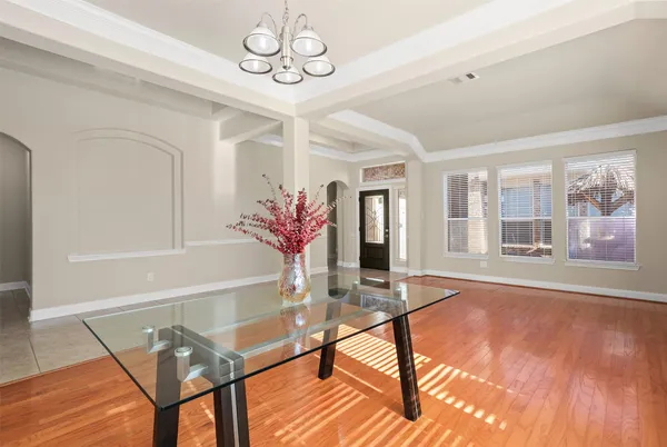 a view of a dining room with furniture wooden floor and chandelier