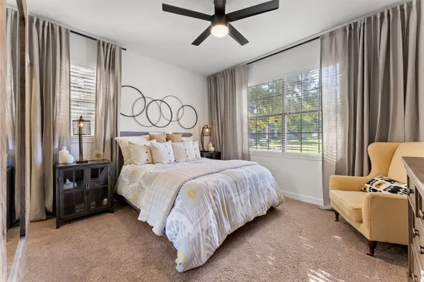 a bedroom with a bed and large window