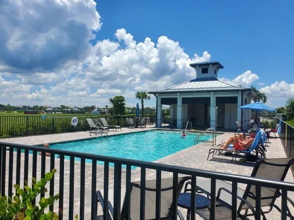 a view of a patio with furniture and a yard