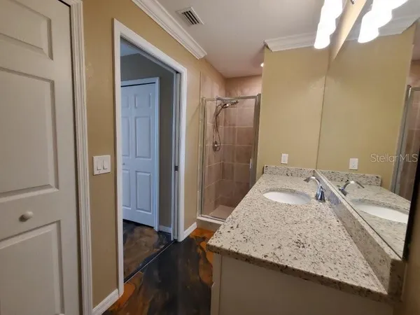 a view of closet with wooden floor