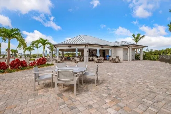 a view of a patio with dining table and chairs with a small yard