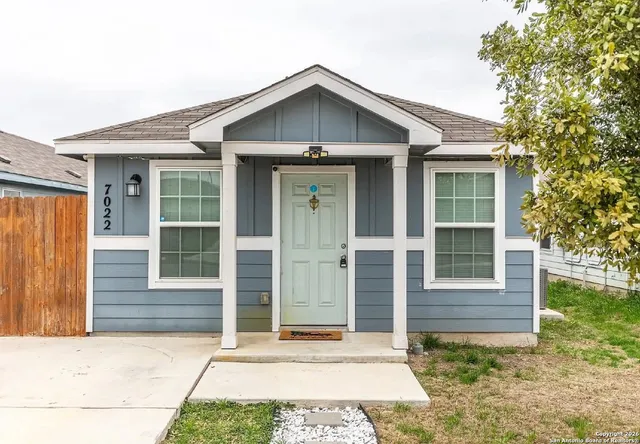 a view of a wooden house with a yard
