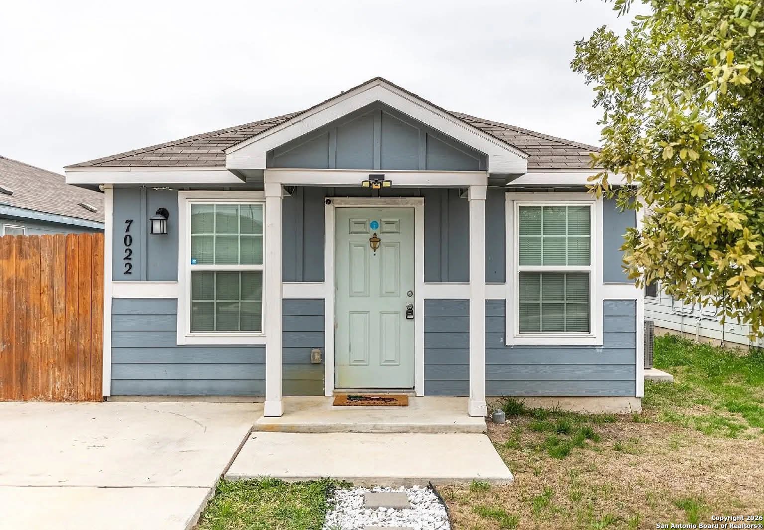 a view of a wooden house with a yard