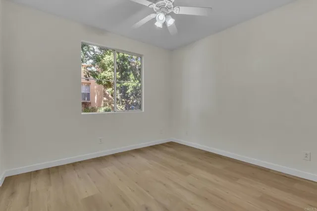 wooden floor in an empty room with a window