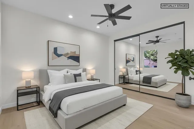 a bedroom with a bed a couch and potted plant with the potted plants