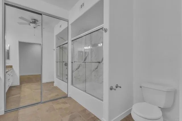 a bathroom with a shower and toilet