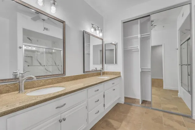 a spacious bathroom with a granite countertop sink mirror and double