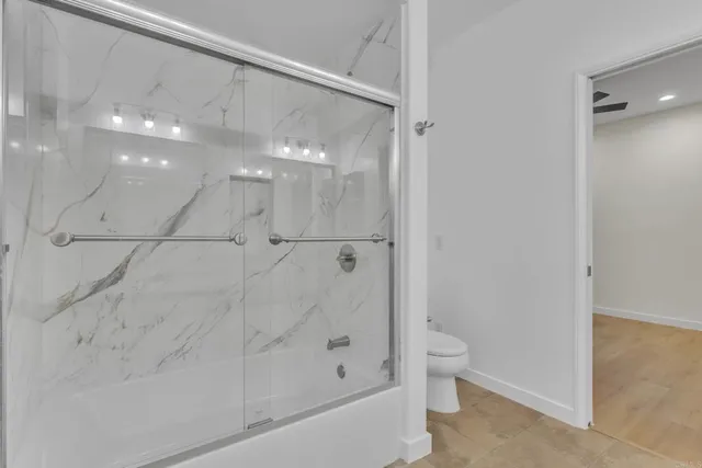 a bathroom with a shower and a toilet