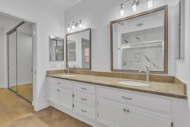 a bathroom with a granite countertop sink mirror and