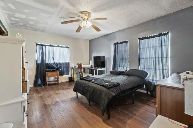 a bedroom with a bed and a chandelier
